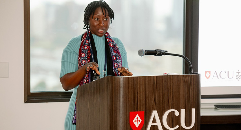 Organising committee member Wimbayi Musodza addresses conference attendees.