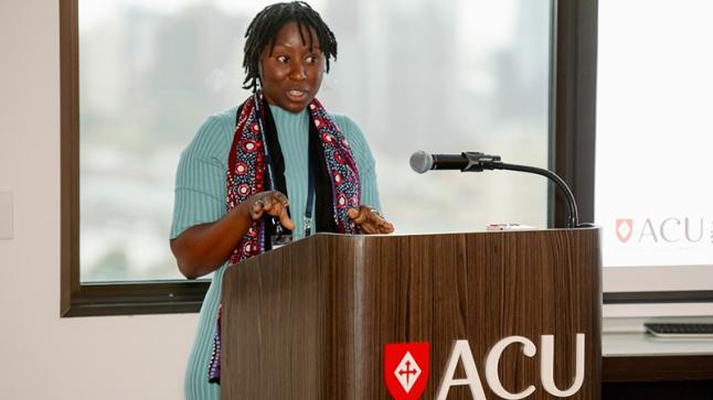 Organising committee member Wimbayi Musodza addresses conference attendees.